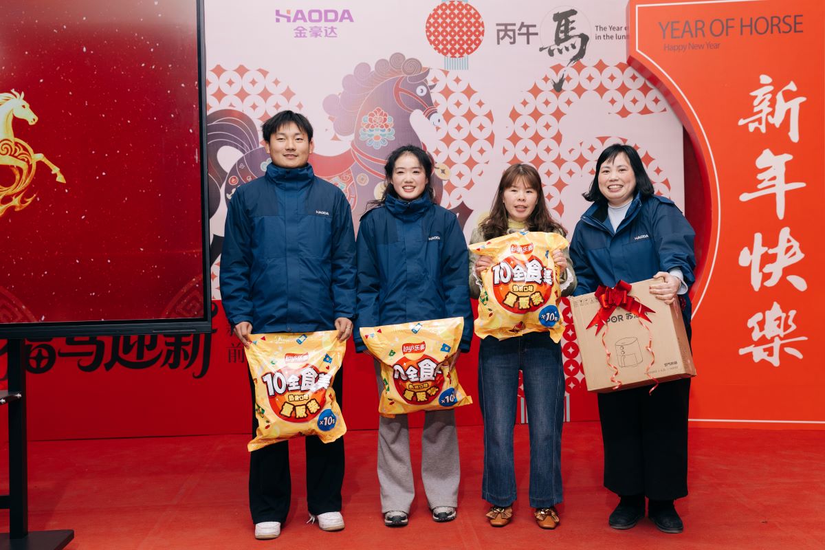 Jinhoda employees holding lucky draw prizes at Spring Festival dinner 2026 Jinhoda employees holding lucky draw prizes at Spring Festival dinner 2026